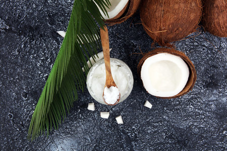coconut oil and fresh coconuts on grey backgroundの写真素材
