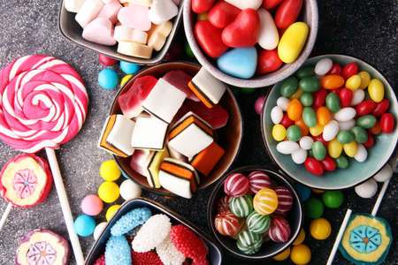 candies with jelly and sugar. colorful array of different childs sweets and treatsの写真素材