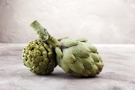 artichokes on grey background. fresh organic artichoke flowerの写真素材