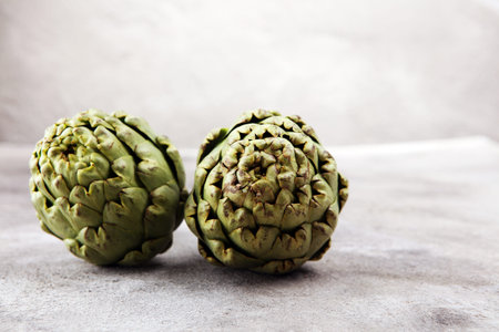 artichokes on grey background. fresh organic artichoke flowerの写真素材
