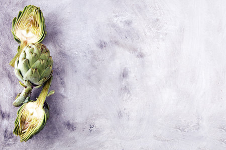 artichokes on grey background. fresh organic artichoke flowerの写真素材