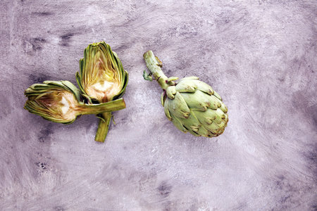 artichokes on grey background. fresh organic artichoke flowerの写真素材