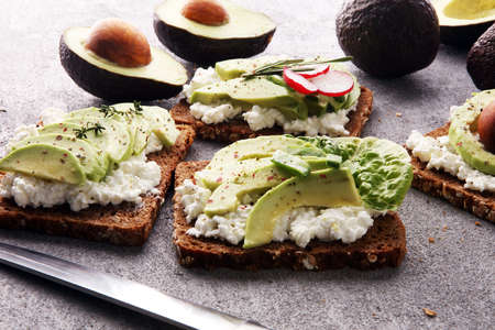 sliced avocado on toast bread with spicesの写真素材