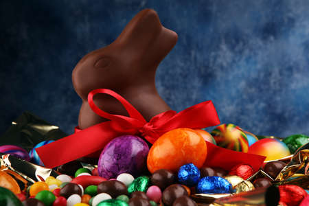 Chocolate Easter eggs and chocolate bunny and colorful sweetsの写真素材