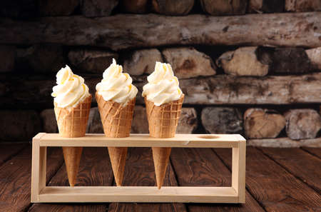 Vanilla frozen yogurt or soft ice cream in waffle coneの写真素材