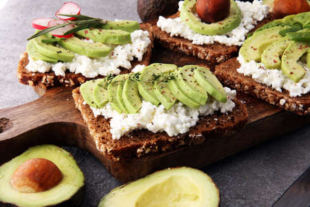 sliced avocado on toast bread with spicesの写真素材