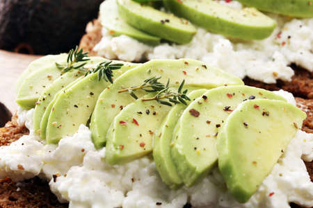 sliced avocado on toast bread with spicesの写真素材