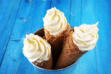 Vanilla frozen yogurt or soft ice cream in waffle cone