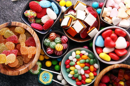 candies with jelly and sugar. colorful array of different childs sweets and treatsの写真素材