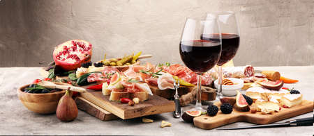 Italian antipasti wine snacks set. Cheese variety, Mediterranean olives, pickles, Prosciutto di Parma, pepper and salamiの写真素材