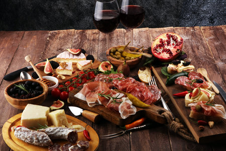 Italian antipasti wine snacks set. Cheese variety, Mediterranean olives, pickles, Prosciutto di...