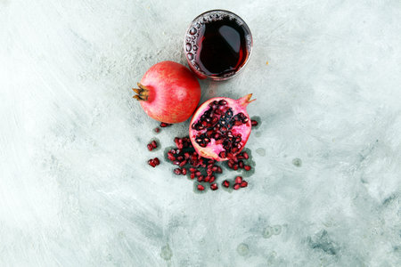 Glass of pomegranate juice and pomegranate fruit and seed