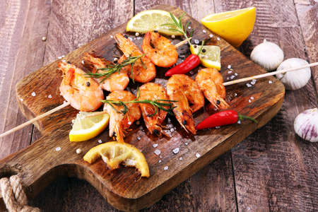 Grilled shrimp skewers. Seafood, shelfish. Shrimps Prawns skewers with herbs, garlic and lemon. Barbecue srimps prawns.の写真素材