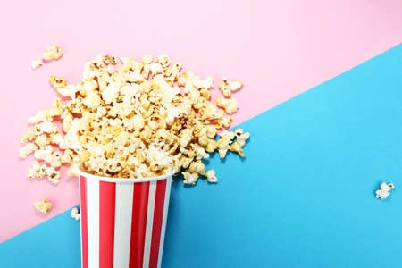 Salt popcorn or sweet popcorn flat lay on colored paperの写真素材