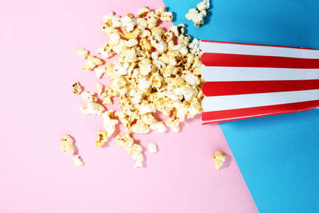 Salt popcorn or sweet popcorn flat lay on colored paperの写真素材