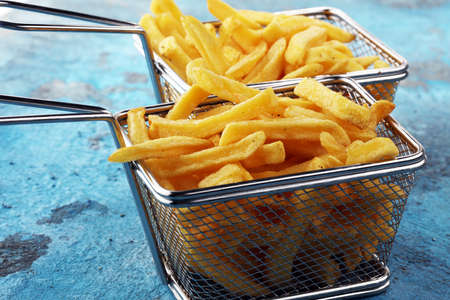 Tasty french fries on blue table backgroundの写真素材