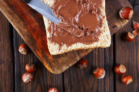 Homemade hazelnut spread with toast and in wooden bowl for breakfast. Hazelnut Nougat cream. 