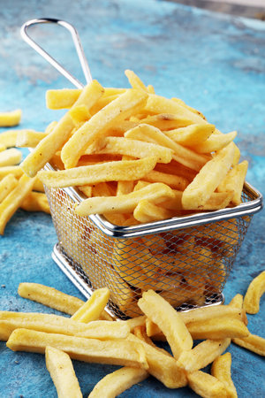 Tasty french fries on blue table backgroundの写真素材