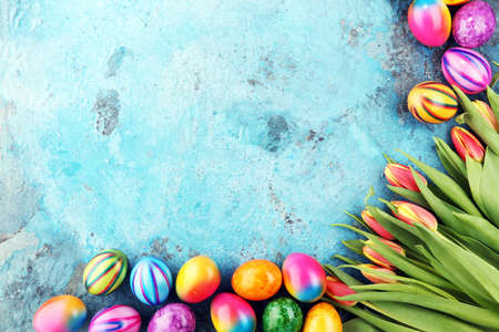 Festive background setting for Easter with eggs and tulipsの写真素材