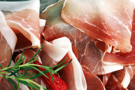 Italian prosciutto crudo or jamon with rosemary. Raw ham.の写真素材