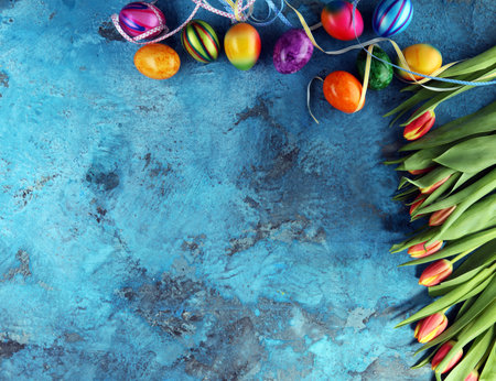 Festive background setting for Easter with eggs and tulips