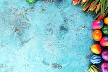 Festive background setting for Easter with eggs and tulipsの写真素材