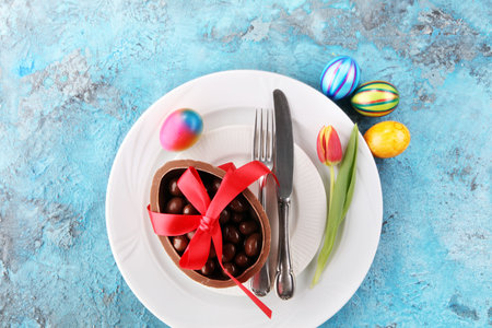 Festive table setting for Easter with fork, knife and tulipの写真素材