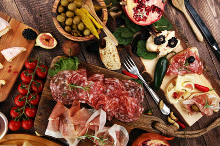 Italian antipasti wine snacks set. Cheese variety, Mediterranean olives, pickles, Prosciutto di Parma, pepper and salamiの写真素材