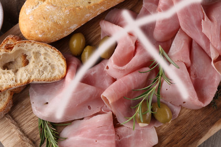 Sliced ham on wooden cutting board. Fresh prosciutto. Pork ham sliced.の写真素材