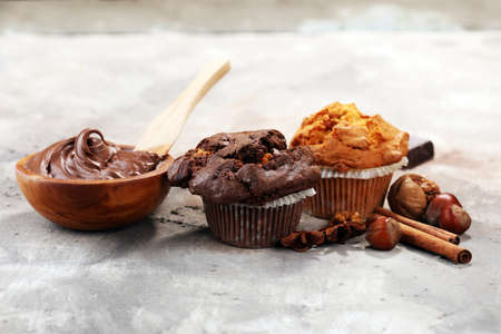 Chocolate muffin and nut muffin, homemade bakery on grey backgroundの写真素材