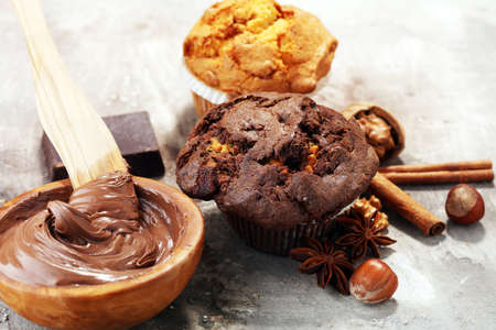 Chocolate muffin and nut muffin, homemade bakery on grey backgroundの写真素材