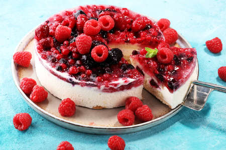 raspberry cake and many fresh raspberries. fresh spring cream cake with blackberries, blueberries and raspberriesの写真素材