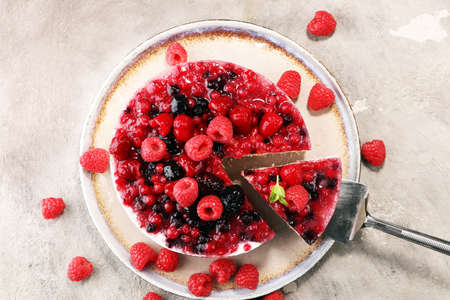raspberry cake and many fresh raspberries. fresh spring cream cake with blackberries, blueberries and raspberriesの写真素材
