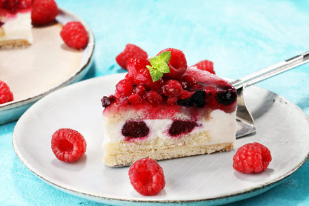 raspberry cake and many fresh raspberries. fresh spring cream cake with blackberries, blueberries...