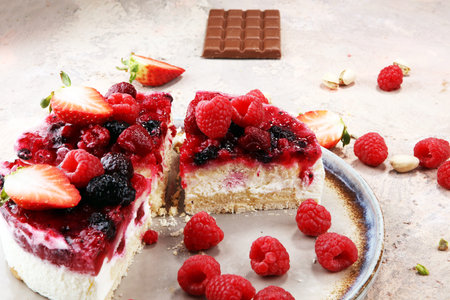 raspberry cake and many fresh raspberries. fresh spring cream cake with blackberries, blueberries and raspberriesの写真素材
