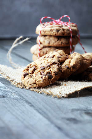Chocolate cookies on wooden table. Chocolate chip cookies shotの写真素材