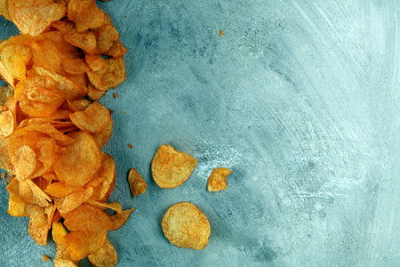 Crispy potato chips. Paprika chips on table. Spicy crunchy chips.