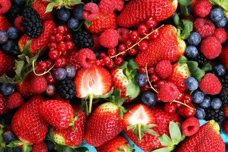 Berries overhead closeup colorful assorted mix of strawberry, blueberry, raspberry, blackberry, red...
