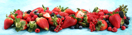 Berries overhead closeup colorful assorted mix of strawberry, blueberry, raspberry, blackberry, red...