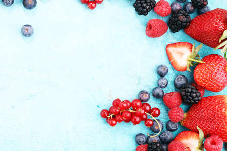 Berries overhead closeup colorful assorted mix of strawberry, blueberry, raspberry, blackberry, red currantの写真素材