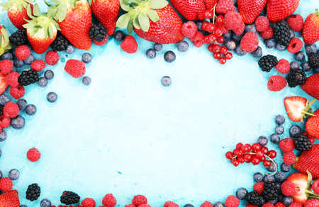 Berries overhead closeup colorful assorted mix of strawberry, blueberry, raspberry, blackberry, red currantの写真素材