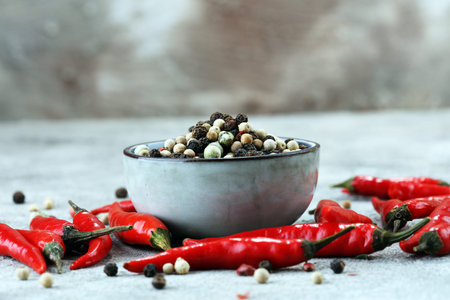 red hot bird chili pepper nature background with pepper corns