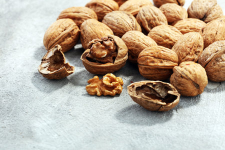 Walnut kernels and whole healthy walnuts on rustic old table