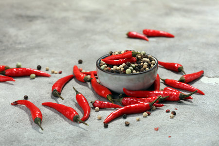 red hot bird chili pepper nature background with pepper corns