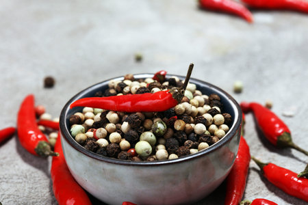 red hot bird chili pepper nature background with pepper corns