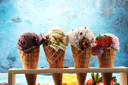 Set of ice cream scoops of different colors and flavours with berries, nuts and fruits 