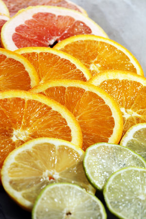 Citrus fruits with orange, lemon, grapefruit and lime on light background
