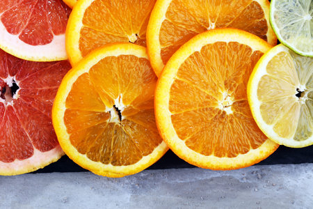 Citrus fruits with orange, lemon, grapefruit and lime on light background