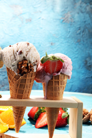 Set of ice cream scoops of different colors and flavours with berries, nuts and fruits 