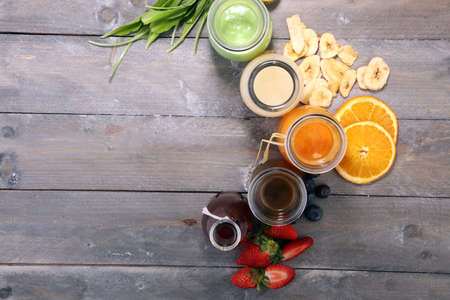 Selection of colorful smoothies on rustic background with vegetables and fruitsの写真素材
